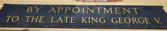 An enamel tin sign and gilt painted wooden sign